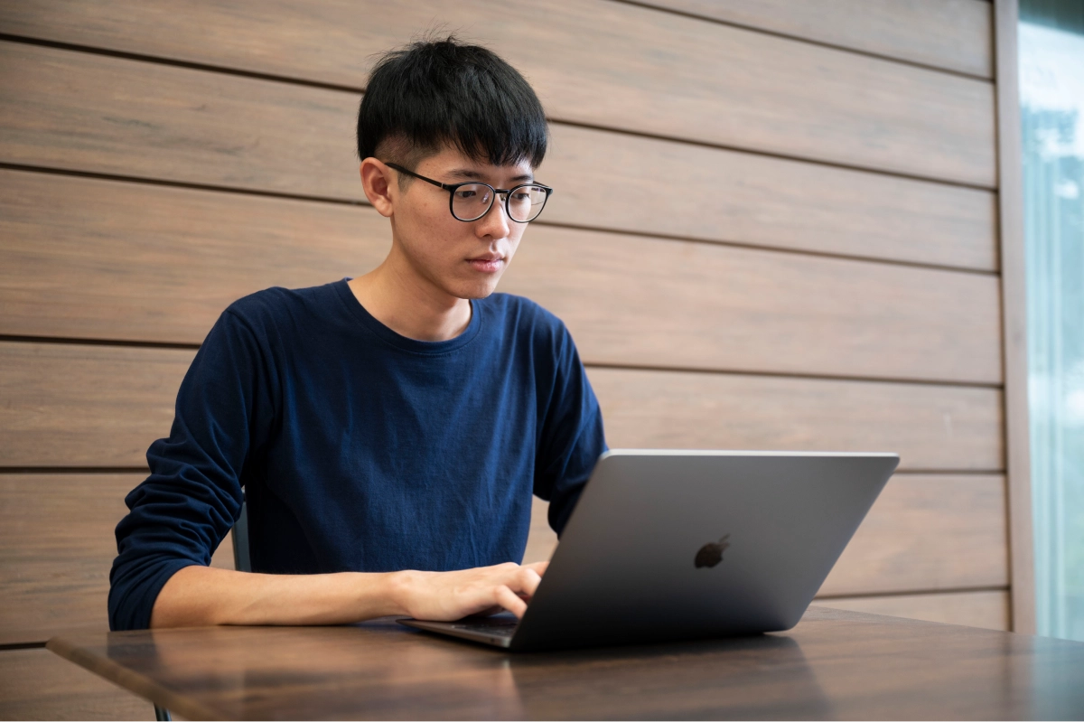 Thammarith - full stack engineer - working on a laptop at Agoda